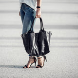 Paris Smooth leather black tote handheld by woman on street